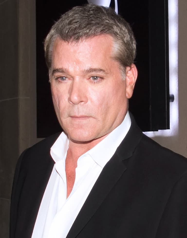 Ray Liotta's intense gaze is highlighted by smoky eye makeup, adding a touch of mystery to his look