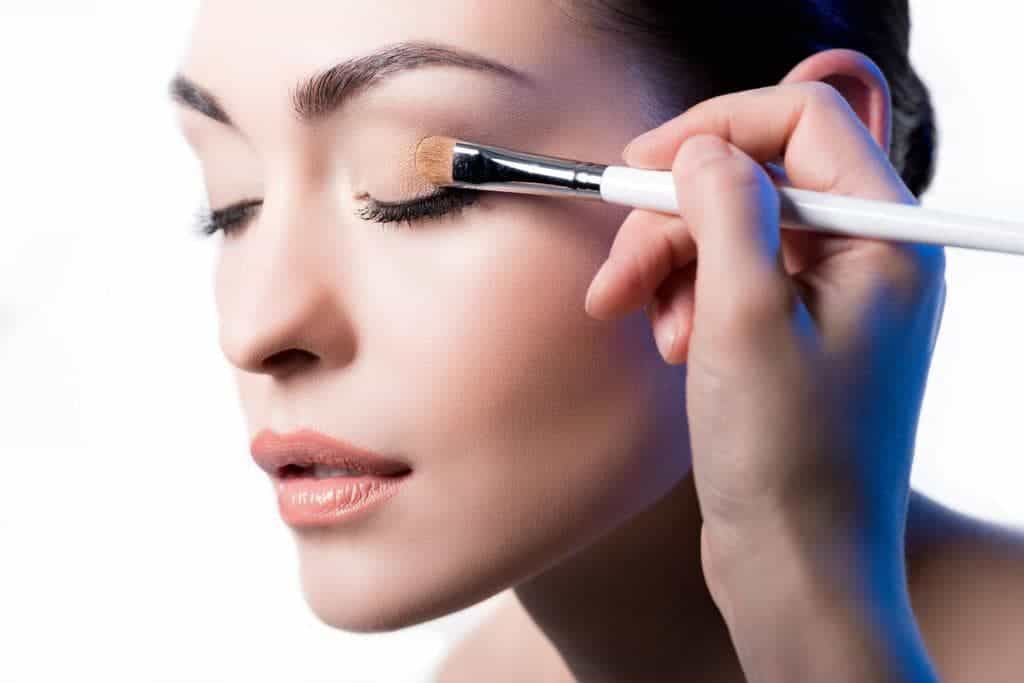 Makeup artist using brush for eye makeup