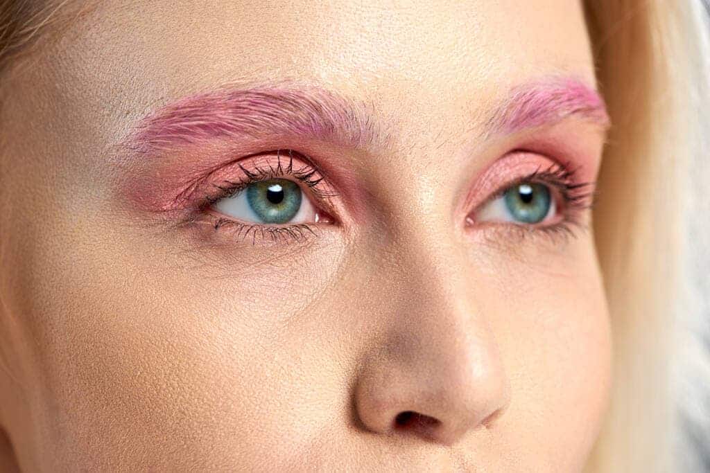 young woman blue eyes with pink eyeshadows eye makeup